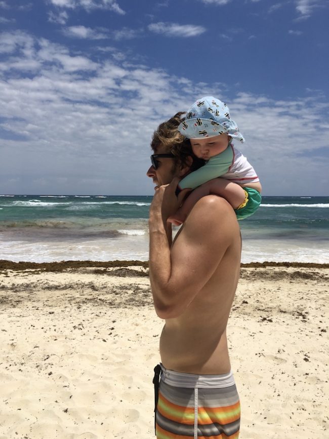 Image of Justin Chiotti and his son Wylie on the beach in Tulum